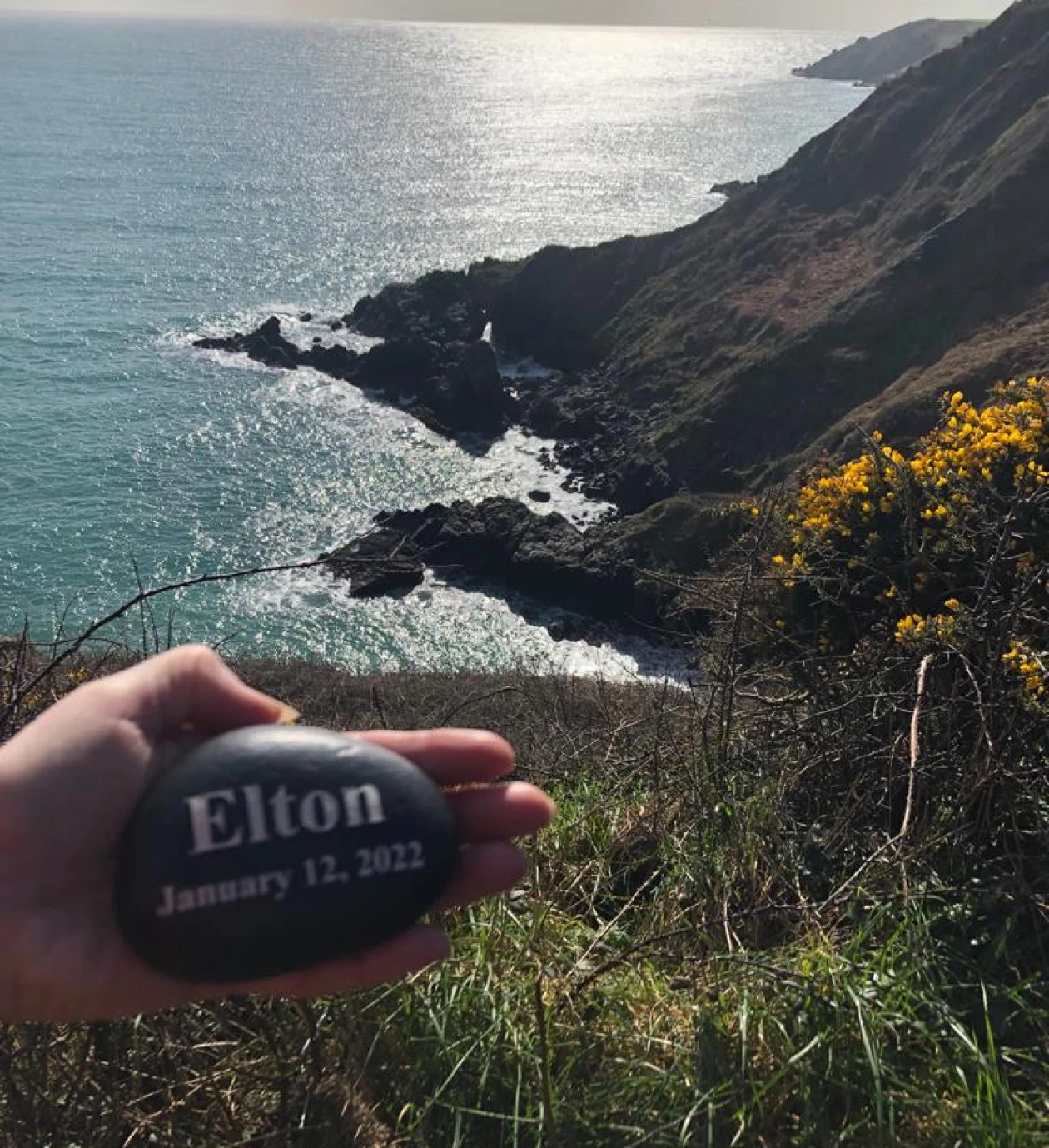 Personalized stone above ocean cliffs